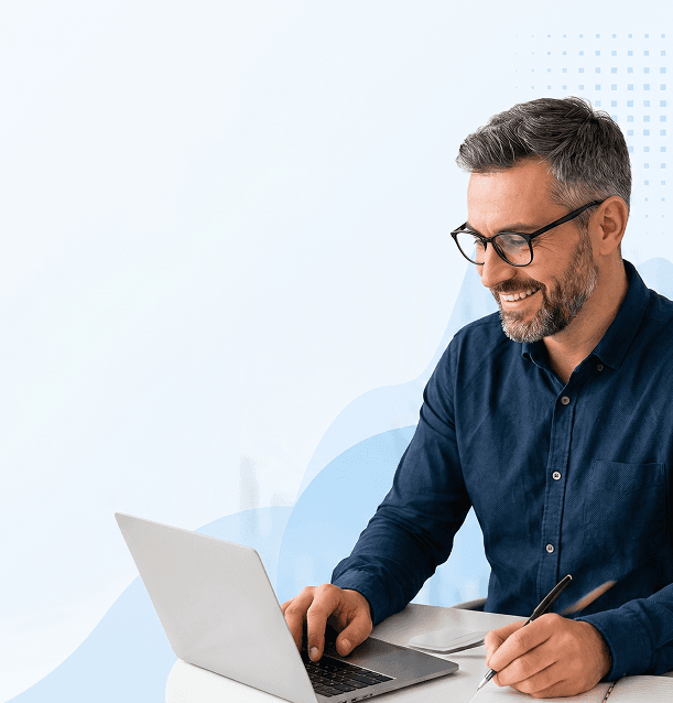Business professional reviewing work on a laptop