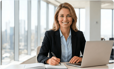 Smiling Australian tax professional working at a desk with a laptop