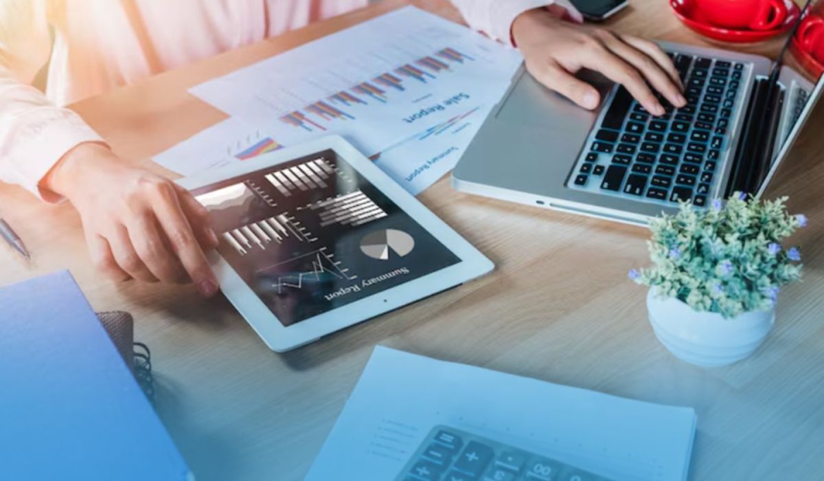 SME owner reviewing summary reports on tablet and laptop