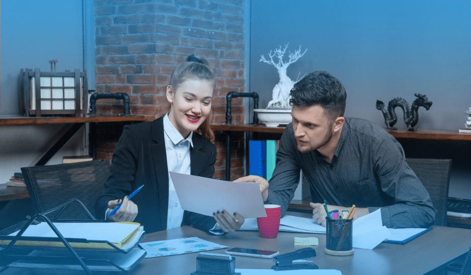 Tax professionals reviewing documents together at a desk