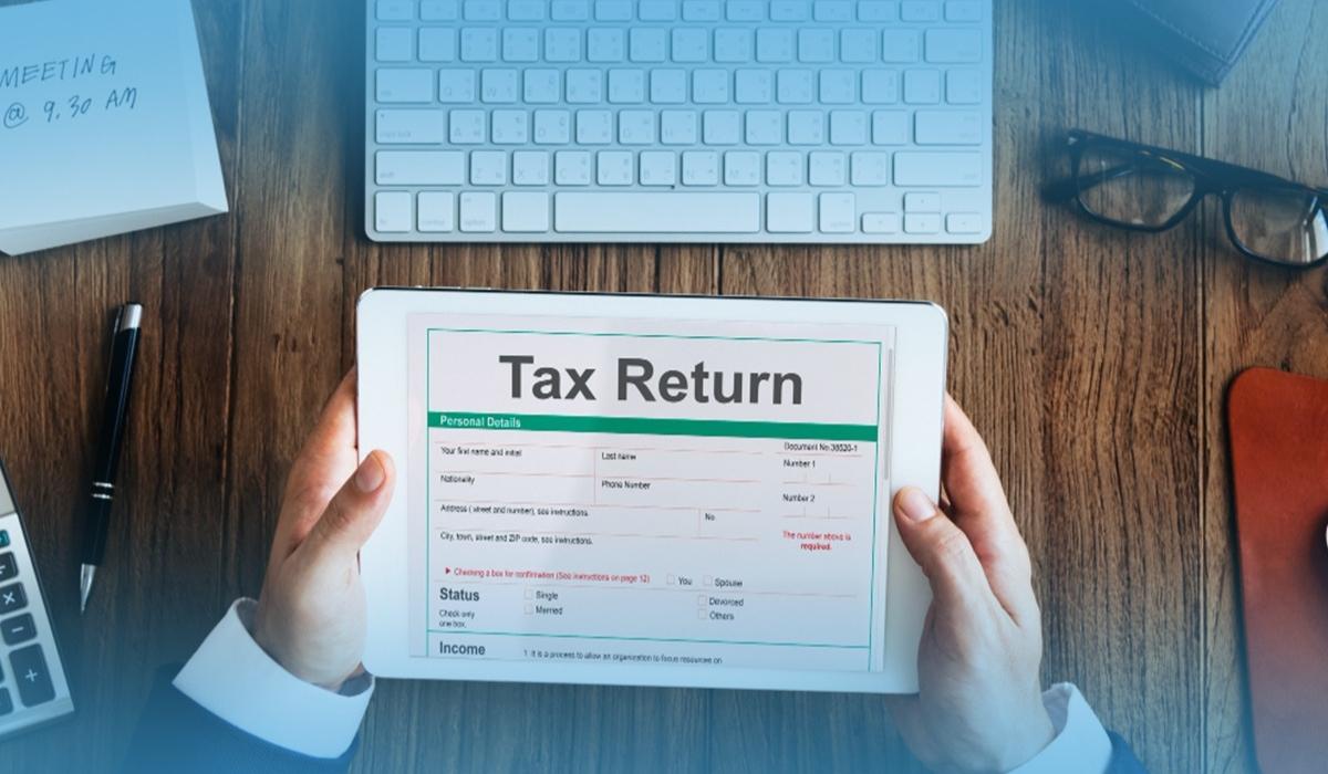 Graduate reviewing tax return details on a tablet